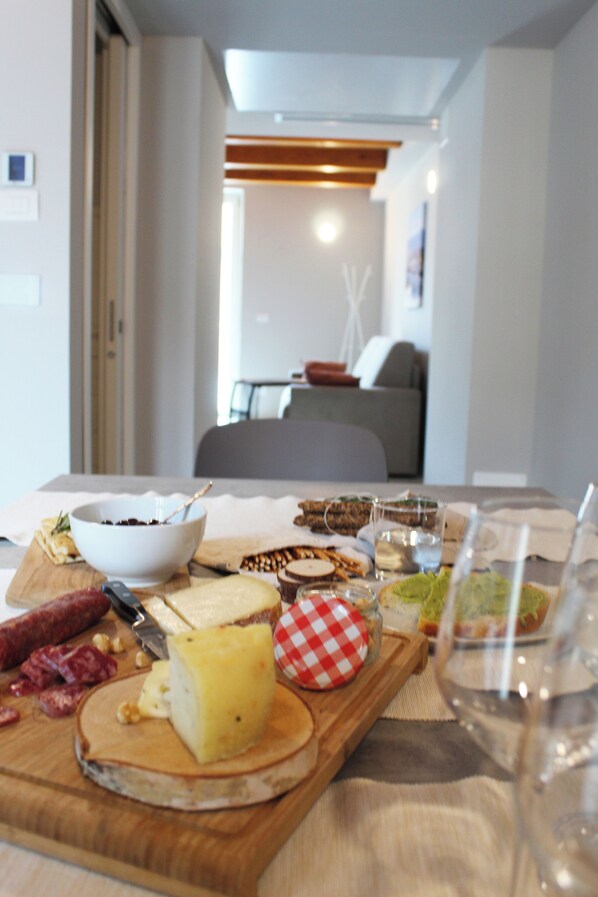 A dining table with various food items and a wine glass. - BENE 39 (Turin)