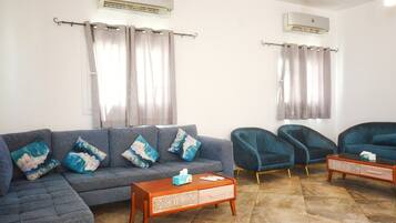 Deluxe Villa | Living area | 55-inch flat-screen TV with cable channels, fireplace