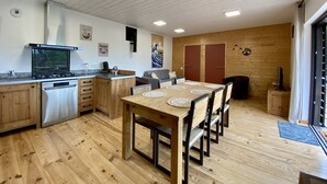 A modern kitchen with wooden cabinets, a built-in stove, and a dishwasher. - New Ecogîte in the countryside, three minutes from all amenities. (Limoux)