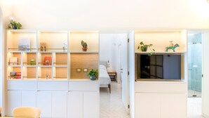 A modern hotel room with a built-in desk, a bed, and a large window. - Two king-size bedrooms villa with pool and sea view (FORIO)