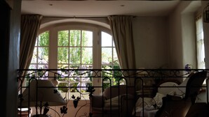 A room with a large arched window, a bed with a white headboard, and a chair. - Vacation Home with Mountain View in the Vercors National Park (IZERON)