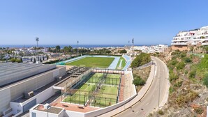 A stadium with a running track, seating areas, and a green field. - Holiday Apartment "Paraíso Azul" with Sea View, Shared Pool (Summer) & A/C (Nerja)