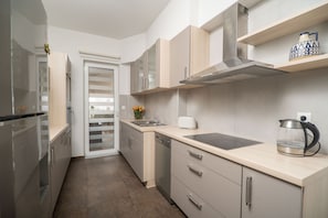 Enjoy cooking in this well-equipped kitchen with a stovetop, double sink, and stainless steel appliances.