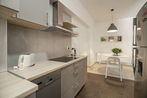 Enjoy cooking in this well-equipped kitchen with a stainless steel range hood, dishwasher, and toaster.