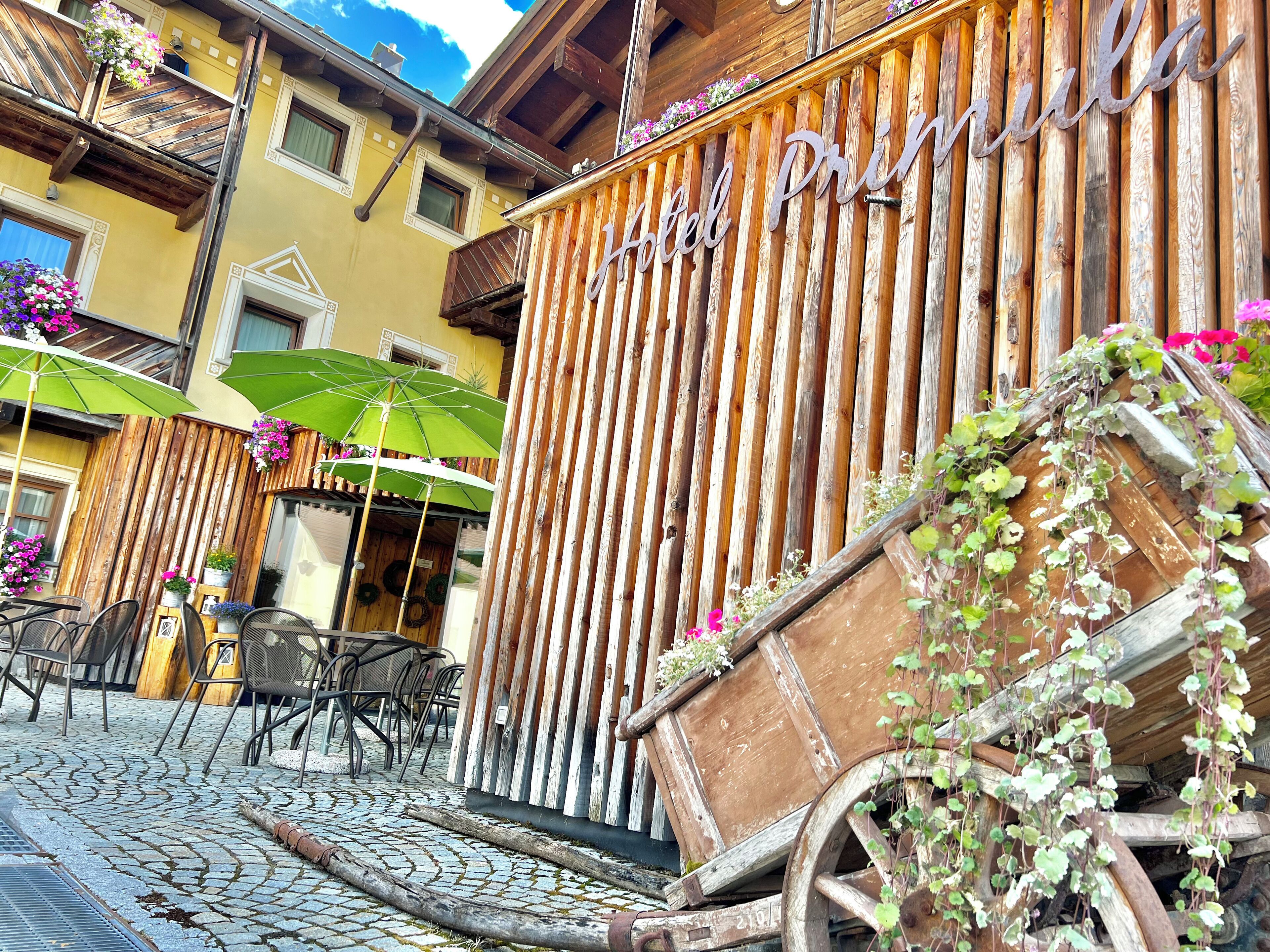 A rustic wooden building with a sign reading "Hotel Prin."
