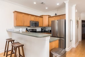 Fridge, dishwasher, coffee/tea maker, cookware/dishes/utensils