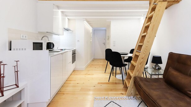 Un apartamento moderno con cocina, comedor y un dormitorio en entrepiso.