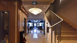 A hotel lobby with a marble floor, a chandelier, a staircase with metal railings, and a reception desk. - ASPEN HOTEL ÇANAKKALE (Çanakkale)