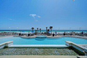 A swimming pool with a view of the beach and ocean.