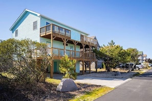 A two-story building with a balcony and a covered porch. - 1-Min walk to Beach! Ocean Views, Hot Tub (Corolla)