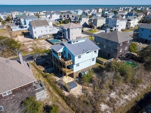 A coastal residential area with houses featuring balconies and a view of the ocean. - 1-Min walk to Beach! Ocean Views, Hot Tub (Corolla)