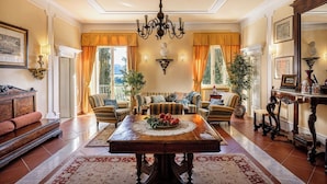 A spacious living room with a large wooden dining table, striped sofas, and a chandelier. - Wonderful private villa with WIFI, A/C, private pool, patio and panoramic view, close to Siena (Poggibonsi)