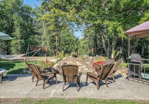 An outdoor patio area with seating and a grill. - Unique and charming, exquisitely themed Log Cabin (Hamilton)