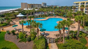 A resort with a large pool, palm trees, and a beach view. - Beautiful Gulf Front 2 Bedroom Condo in Destin (Miramar Beach)