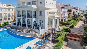 A large white building with a swimming pool, multiple balconies, and a well-maintained garden. - Old Village (Loulé)