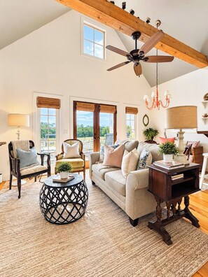 A spacious living room with a high ceiling, a ceiling fan, and large windows. - The Cottage, Firepit+ Animals, VelvetDitchVillas (Oxford)