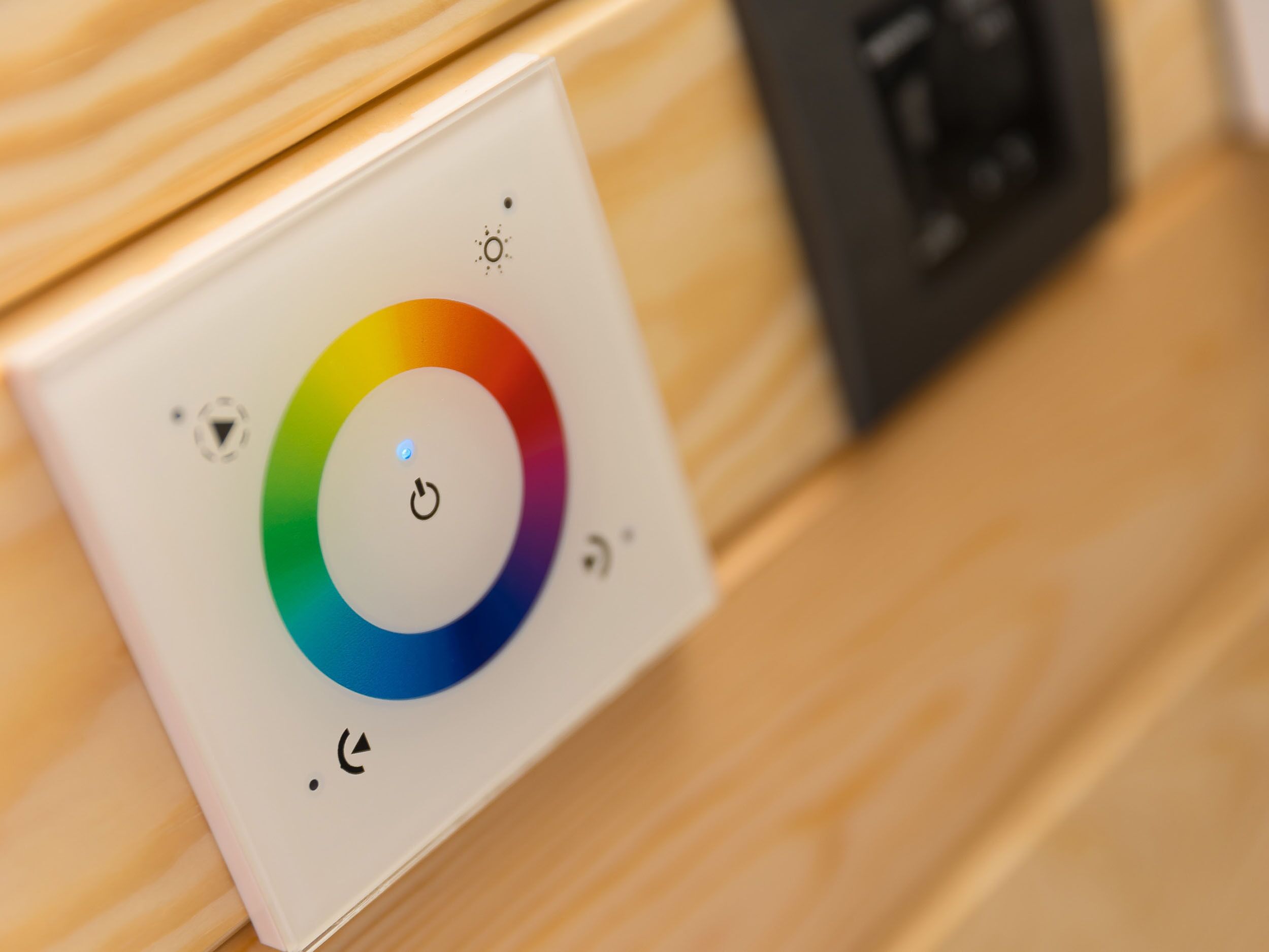 A control panel with a color wheel and power button.