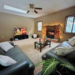 Relax in this stylish living room with a comfortable sofa, coffee table, and large potted plant.