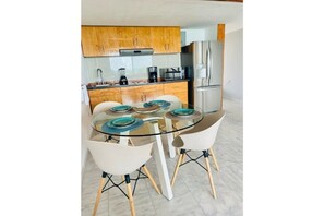Enjoy meals at the glass-top dining table surrounded by four chairs.