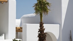 A white building with a palm tree in front. - ISholidays Mykonos Villa Zircon (Tourlos)