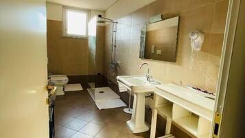 Un baño con ducha, inodoro y lavabo.