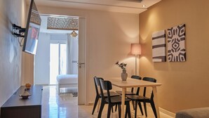 A modern dining area with a table, chairs, and a vase of flowers. - StayHere Rabat - Hassan Heritage (Rabat)