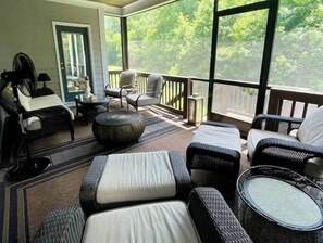 Relax in a serene outdoor space with wicker chairs, sofas, and a small table.