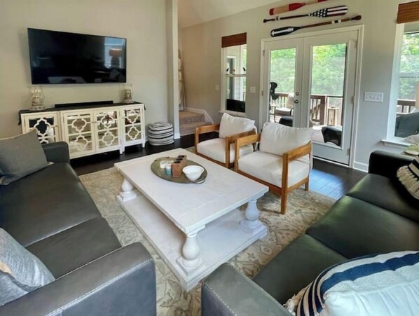 Relax in style with a flat-screen TV, comfortable seating, and a sliding door to an outdoor area.