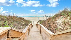 A wooden boardwalk leading to a beach with a clear sky and clouds. - Sandpoint Seaclusion with PRIVATE HEATED POOL,OCEAN VIEWS,ELEVATOR& Beach Access (Port Aransas)