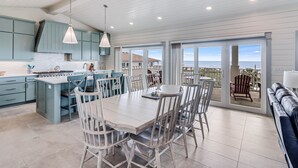 A spacious kitchen with a large island, light blue cabinets, and a view to the outdoors. - Sandpoint Seaclusion with PRIVATE HEATED POOL,OCEAN VIEWS,ELEVATOR& Beach Access (Port Aransas)
