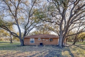 A single-story building with a brown roof and a small porch.