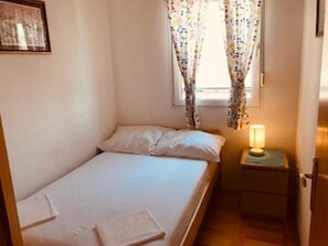 A small, single-bed room with a bedside table and a lamp. - Apartments Marijana Žaborić - sea view A1 (Žaborić)