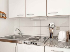 Fridge, stovetop, electric kettle, cookware/dishes/utensils