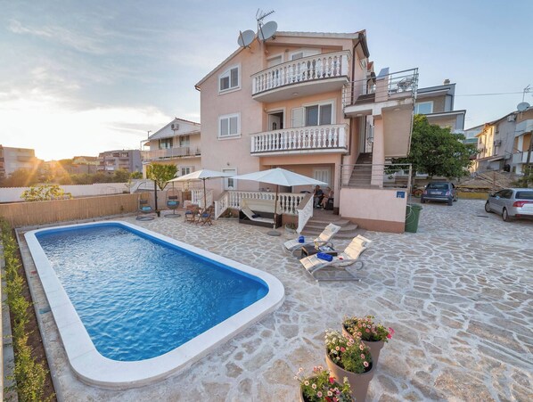 Enjoy a refreshing dip in the pool and unwind in the outdoor seating area.