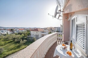 Enjoy a serene view of the surrounding neighborhood from this balcony.