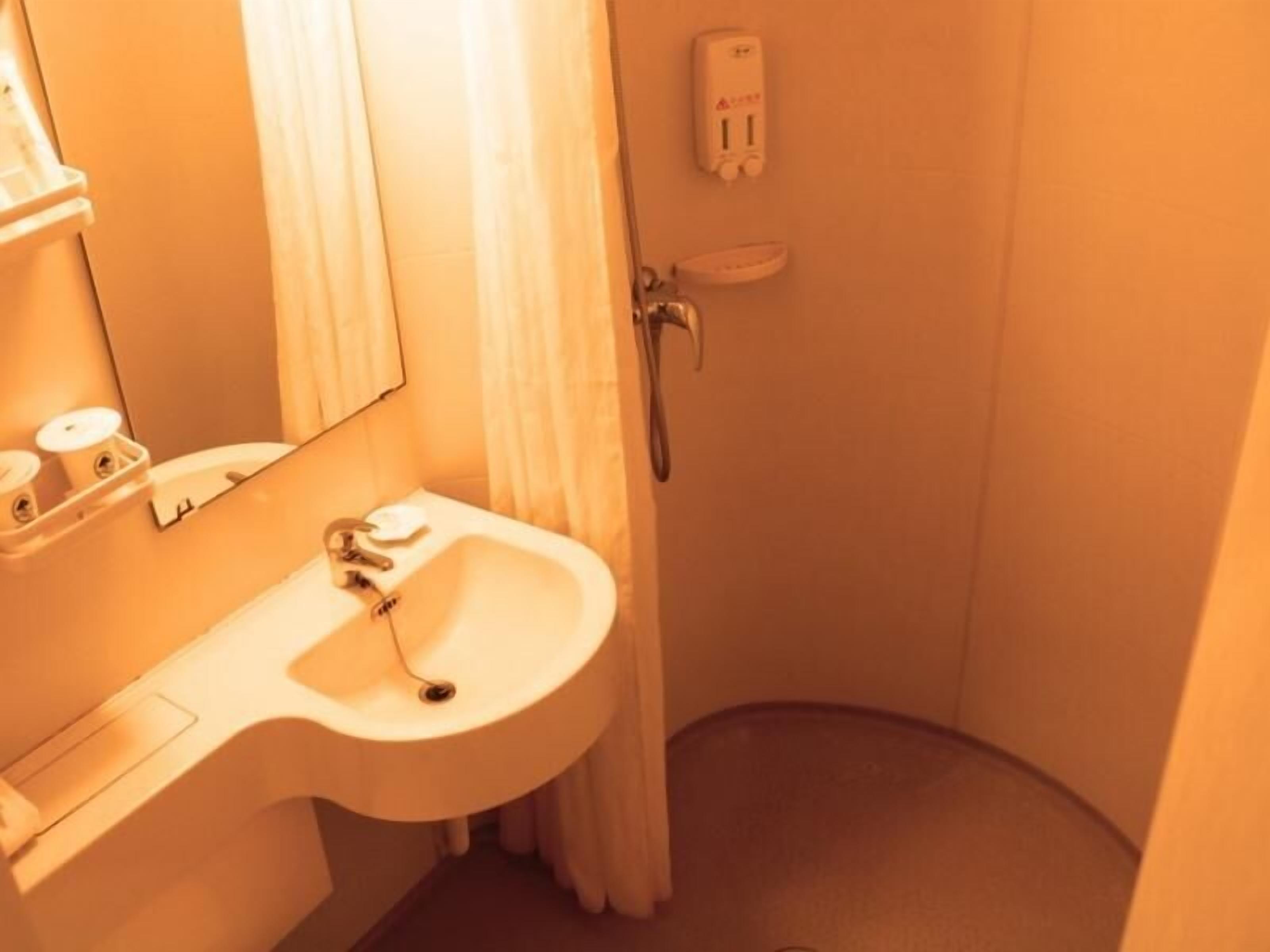 A bathroom with a sink, mirror, towel rack, and a hand dryer.