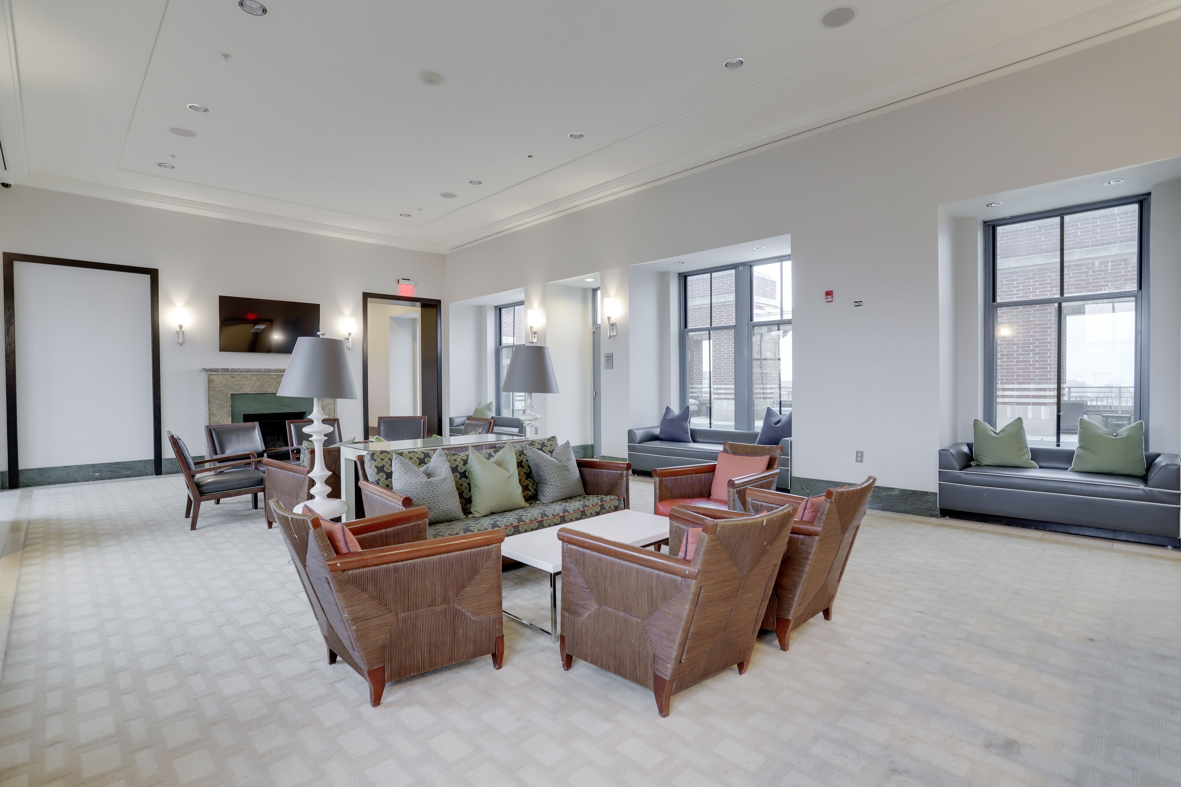 A spacious living room with a large sofa, multiple chairs, and a fireplace.