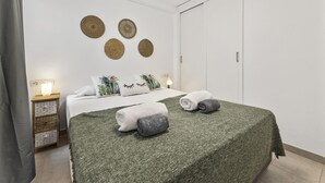 A neatly arranged bedroom with a bed, pillows, and a nightstand. - "Ocean View" Apartment in Lanzarote | Canary Islands - Spain (Tías)