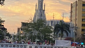 A Gothic-style church with a tall spire, a bridge with decorative railings, and a crowd of people. - Breathe in a quiet and safe forest  (Cali)
