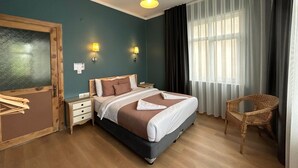 A bedroom with a bed, bedside tables, a lamp, a chair, and a window with curtains. - Istanbul Gem: 3-Bedroom Apartment with Panoramic Terrace and Iconic Sea Views (İstanbul)