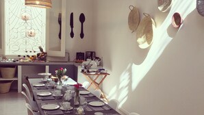 A dining area with a long table set for a meal, surrounded by chairs. - Fra Cielo e Mare (Cagliari)