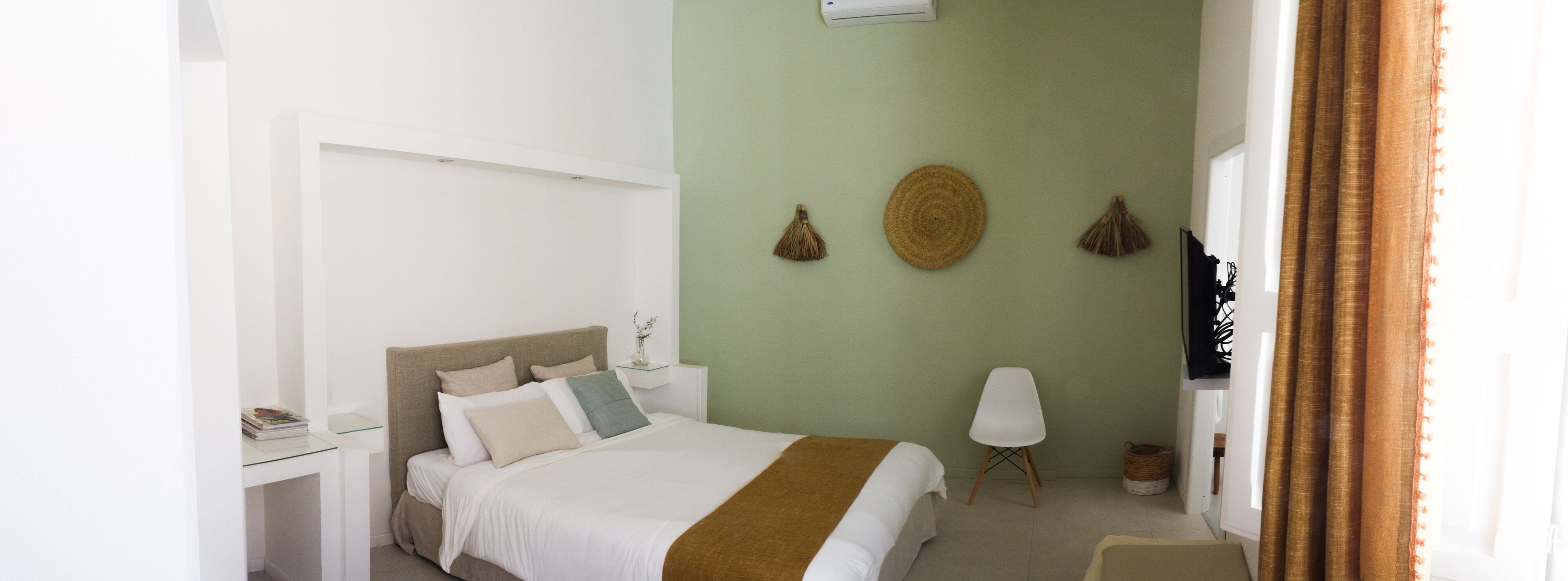 Un dormitorio con cama, mesita de noche y una silla.
