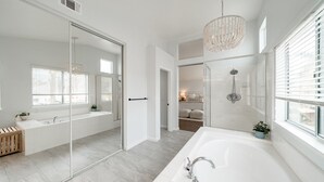 A modern bathroom with a large mirror, a walk-in shower, and a separate bathtub. - Villa Paloma::Private escape with Pool & Hottub (Oceanside)