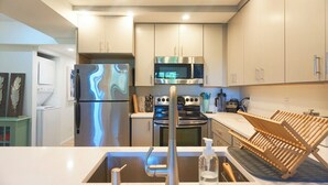 A modern kitchen with stainless steel appliances, a built-in oven, and a microwave. - 2 Bdrm/2 Bath, Sleeps 6, Pool, Balcony, Wi-Fi, TVs (Ocean City)