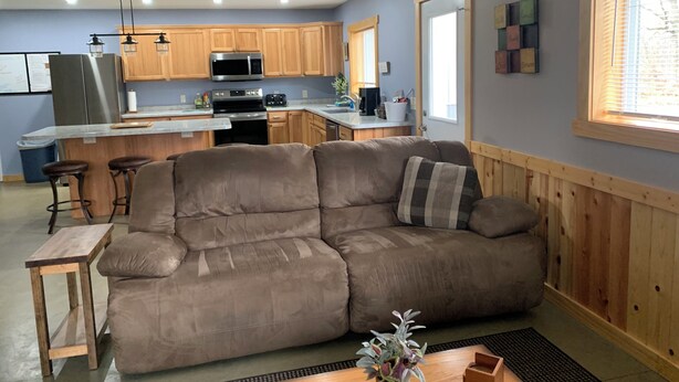 A modern kitchen with wooden cabinets, a stainless steel refrigerator, and a built-in oven. - UpNorth Getaway with access to ATV UTV Snowmobile Trail (Birchwood)
