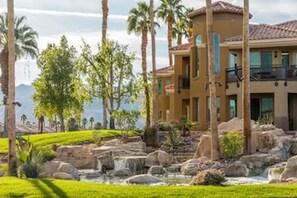 Stunning Mediterranean-style building with a landscaped garden and water feature.