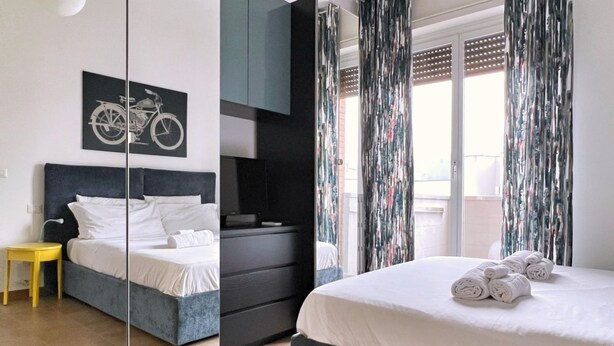 Une chambre à coucher moderne avec un lit, une petite table, une armoire et un miroir.