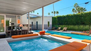 A modern outdoor pool area with lounge chairs and a barbecue setup. - 25% Off Sep 3-6 Perfect 4 Families -Pool, Jacuzzi* (Palm Springs)