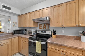 A kitchen with wooden cabinets, stainless steel appliances, and granite countertops. - 2 Bed 2 Bath Centrally Located (Siesta Key)