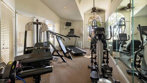A home gym with exercise equipment, a treadmill, and a mirrored wall. - Precious Condo, 3 Blocks to Beach.. Happy Place! (Indialantic)